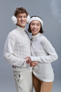 smiley interracial couple in cozy knitted sweaters 2023 11 27 05 34 23 utc