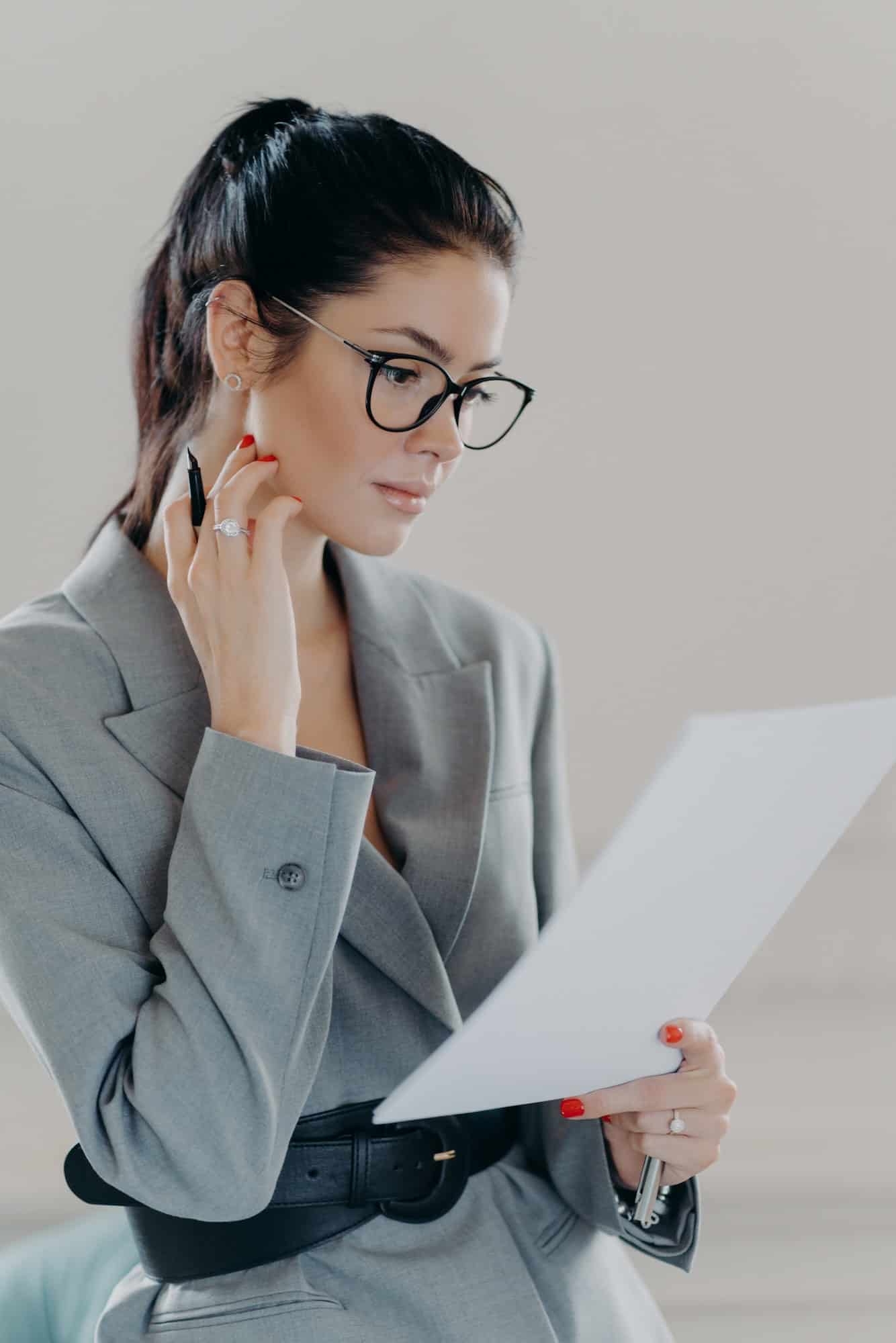 successful female executive manager looks through paper documents analyzes data